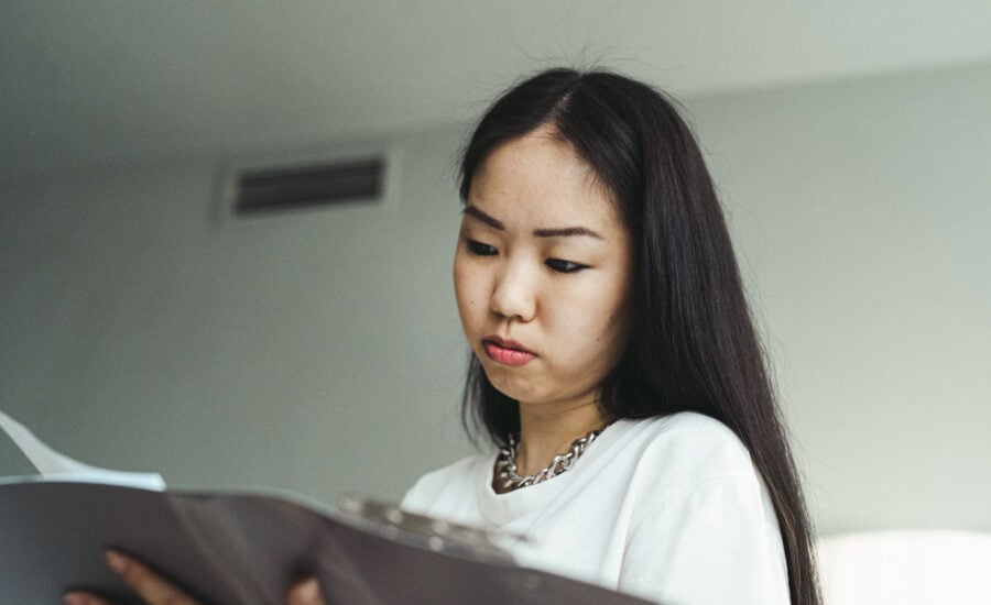 A woman is looking at her notice of assessment to determine her RRSP contribution room.