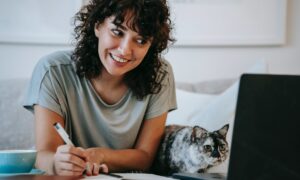 A woman uses an online mortgage calculator from her laptop at home