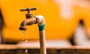 A pipe drips slowly, illustrating the need for home insurance that covers water damage