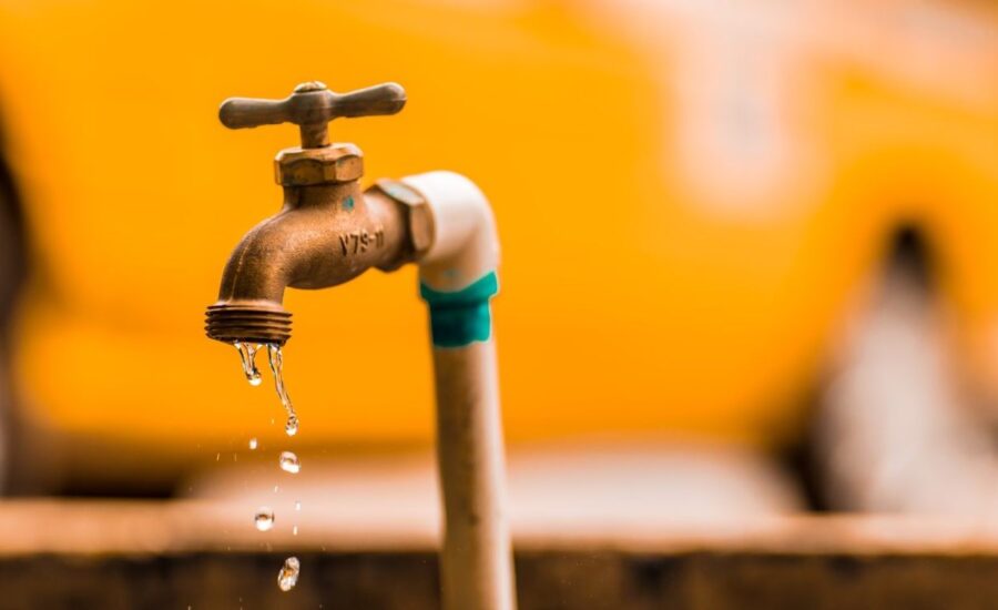 A pipe drips slowly, illustrating the need for home insurance that covers water damage