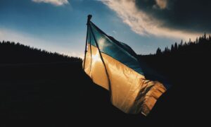 A flag is seen flying over a hroizion