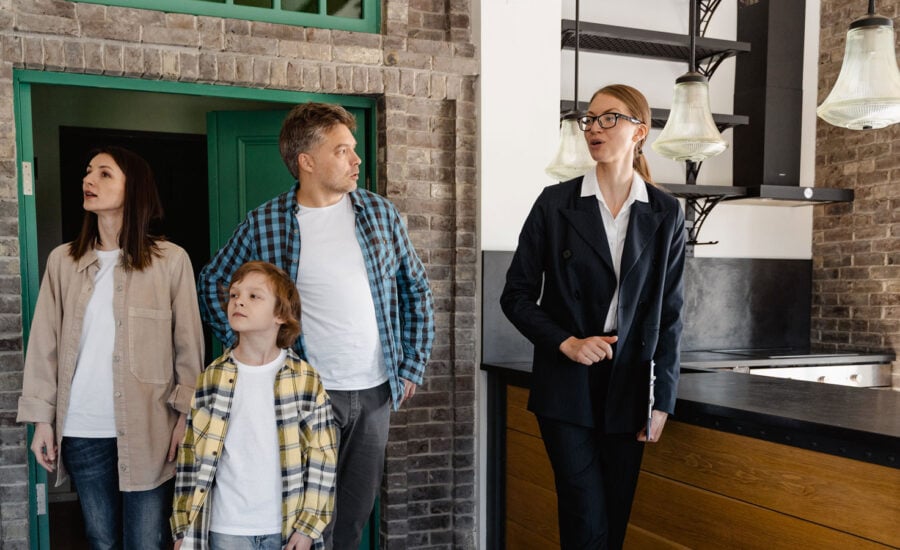 a family is being shown around a rental property that is for sale.