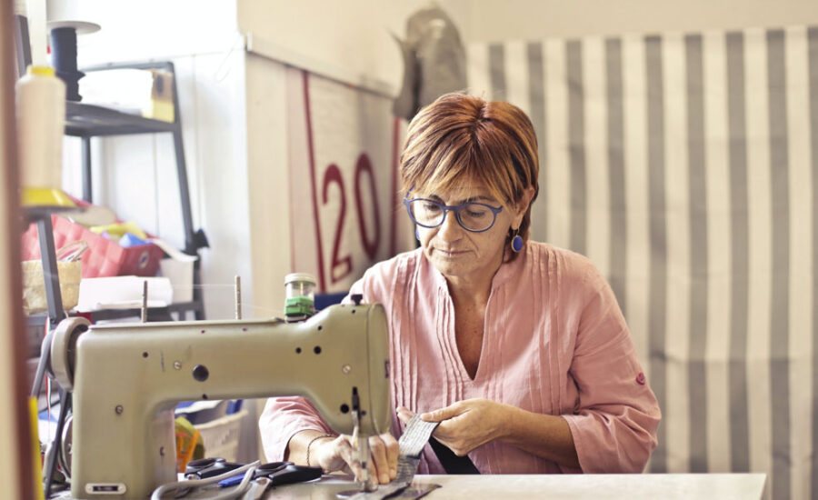 A woman in her retirement years sitting at a sewing machine