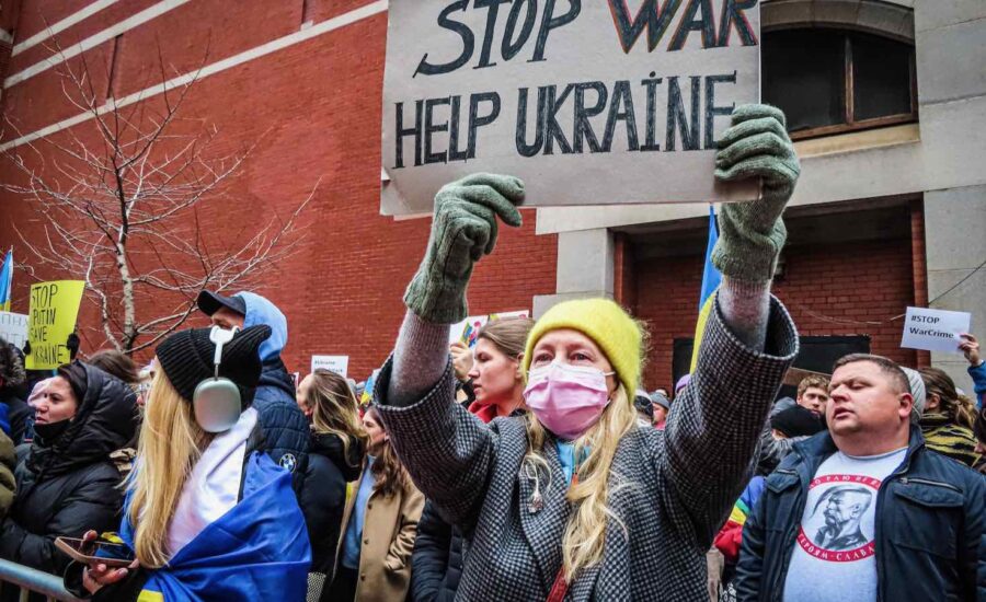 A woman protestor is seen holding up a sign saying stop war Help UkrainePhoto by Katie Godowski from Pexels