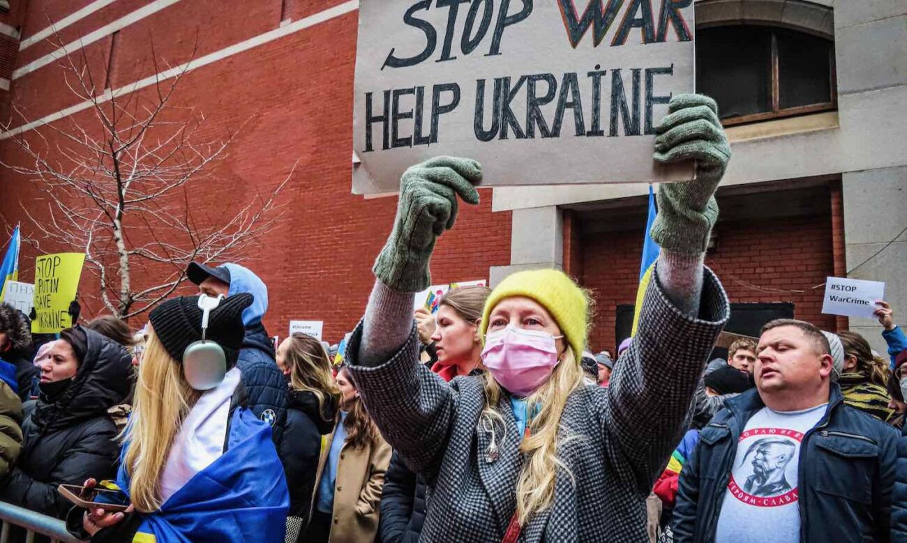 A woman protestor is seen holding up a sign saying stop war Help UkrainePhoto by Katie Godowski from Pexels