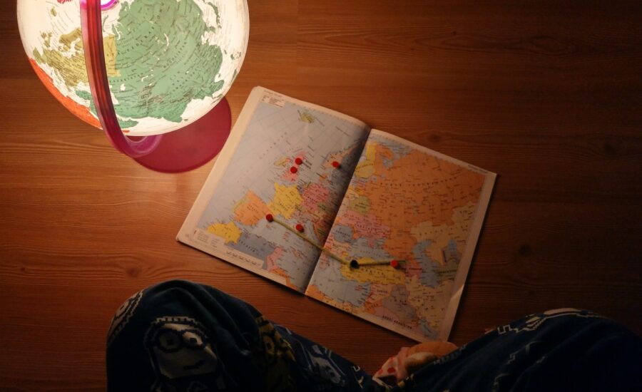 A photo of a map is seen spread out accross a desk