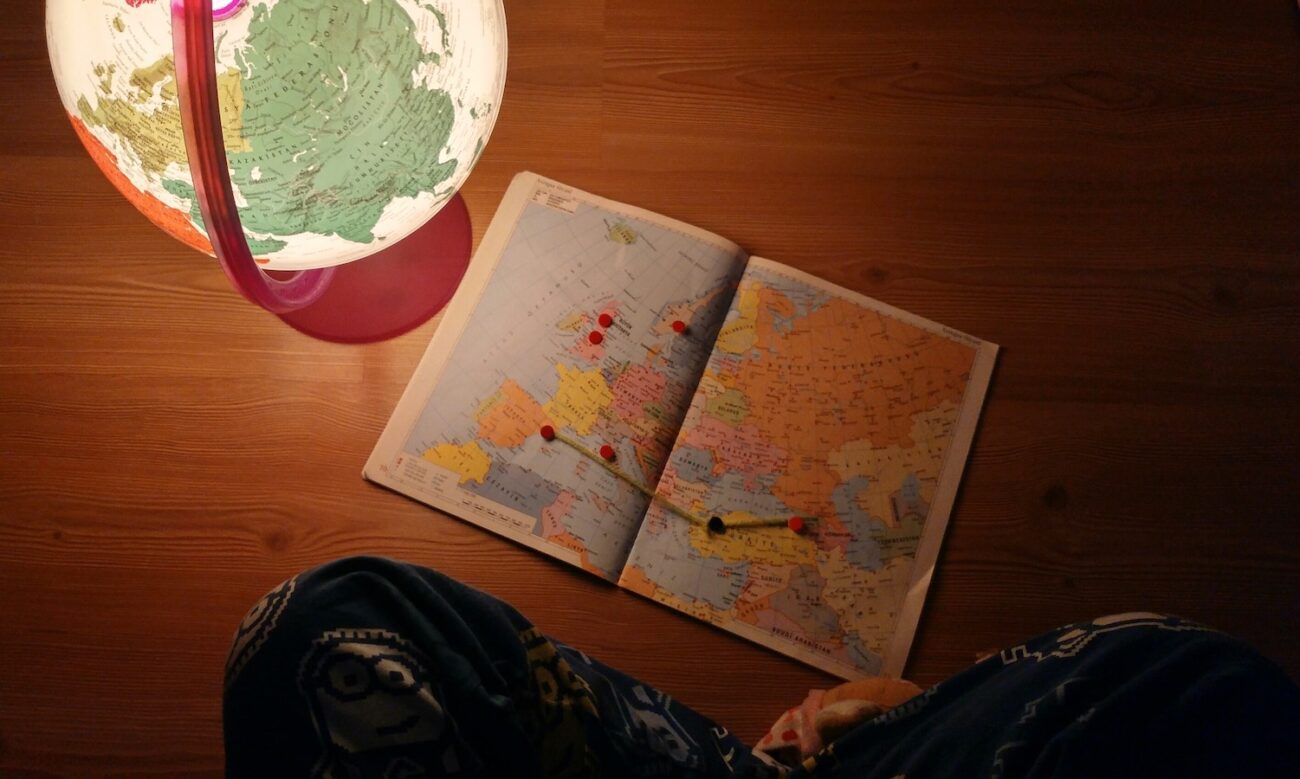 A photo of a map is seen spread out accross a desk