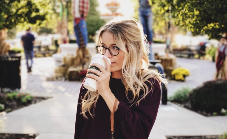 blonde-woman-with-glasses-sips-starbucks-coffee-outside