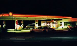 A photo of the gas station is seen in the background