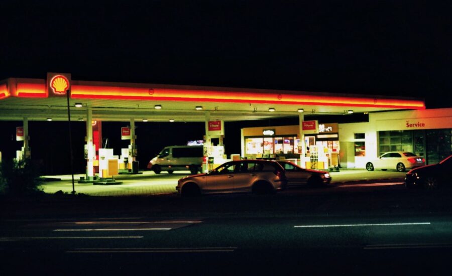 A photo of the gas station is seen in the background