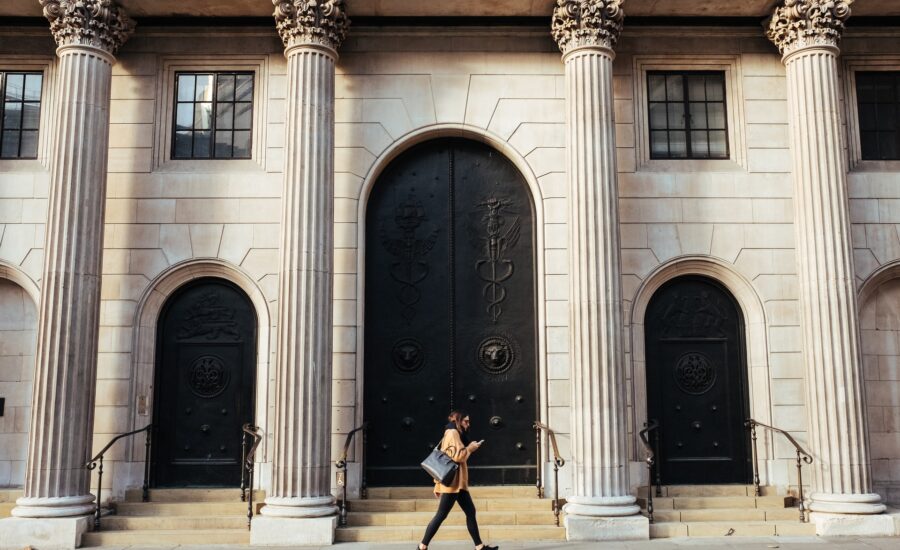 woman walking by bank