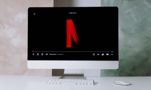 A photo of the faded out netflix logo is seen on a screen