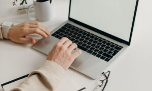 A man signing on to his computer (meant to represent the writer as he writes his last installment for this column)