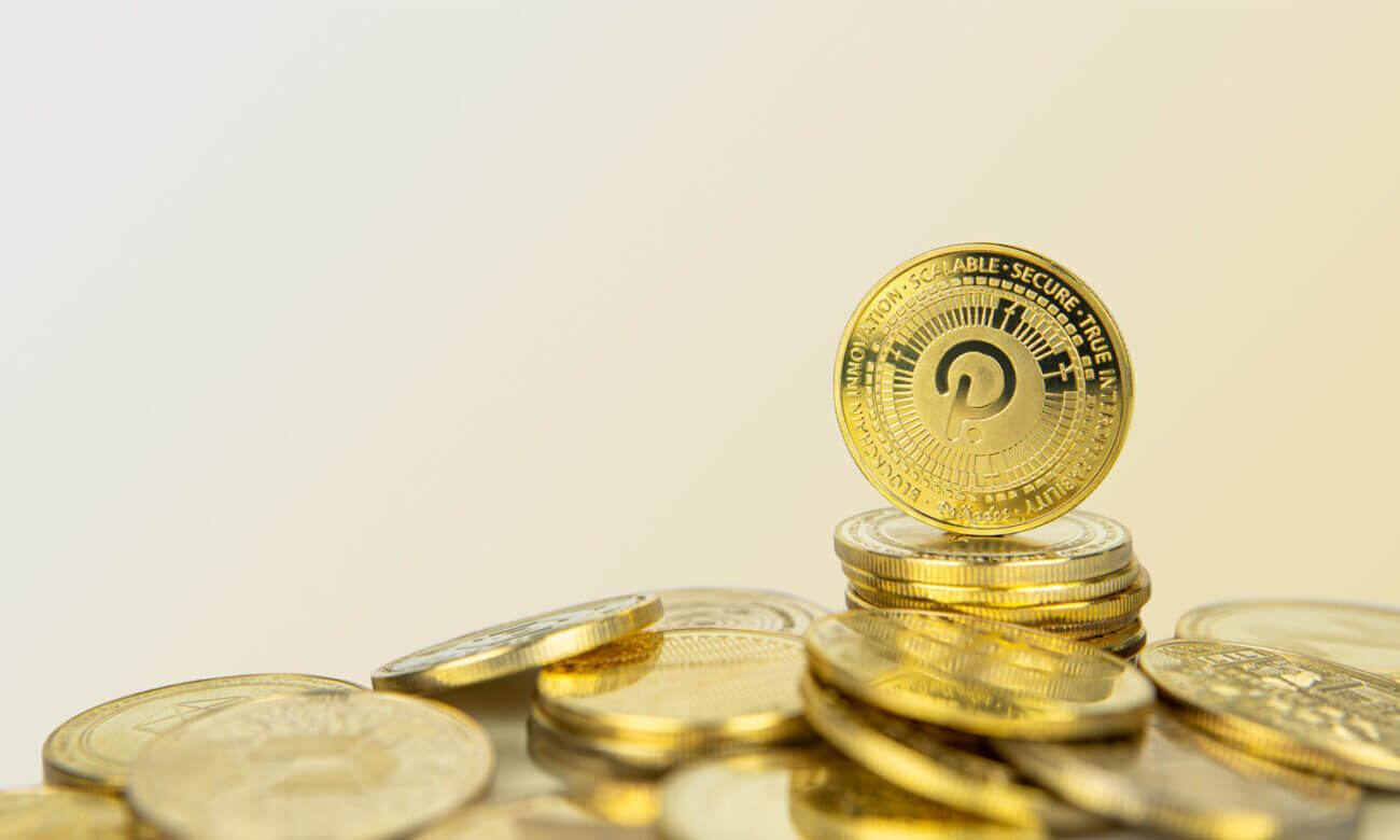 A pile of gold coins with the Polkadot logo