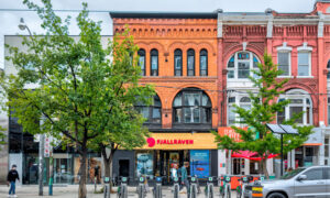 A three-storey retail building on a street in downtown Toronto