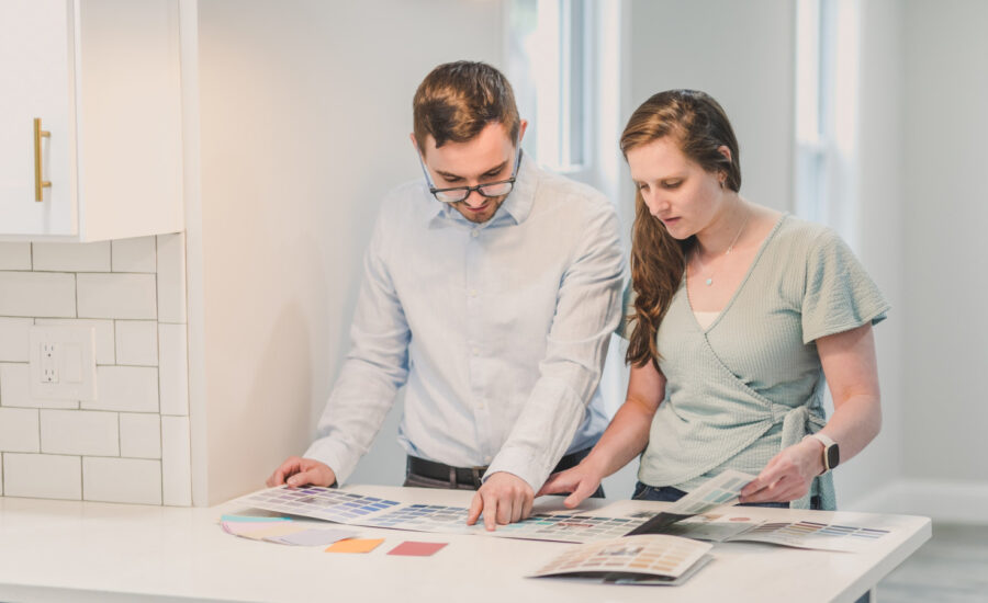 A couple consider paint samples after purchasing their first home