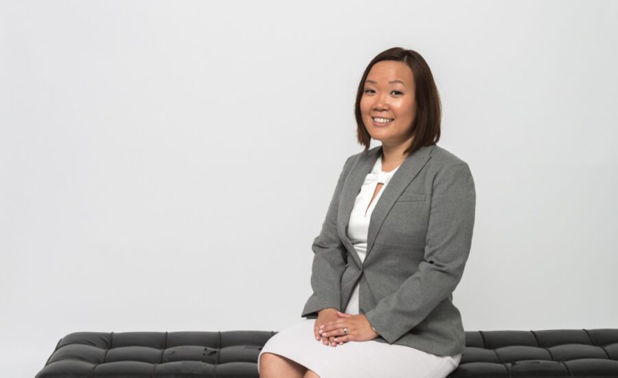 sandy yong sits on an ottoman