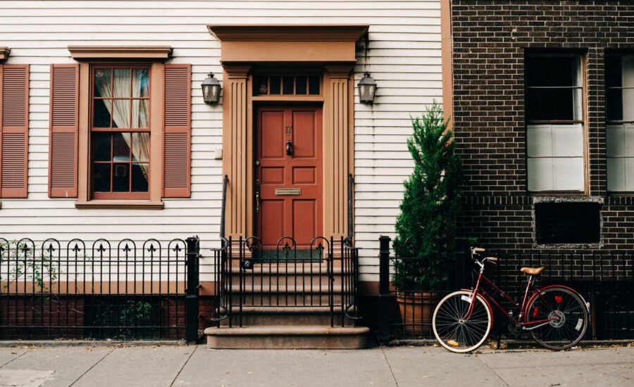 Front door of a home with a bicycle parked in front