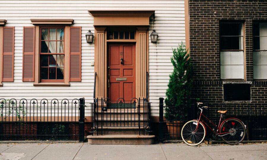 Front door of a home with a bicycle parked in front