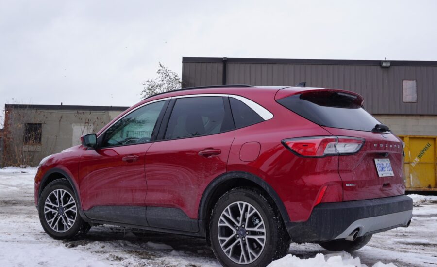 A red Ford Escape sits in a snowy parking lot