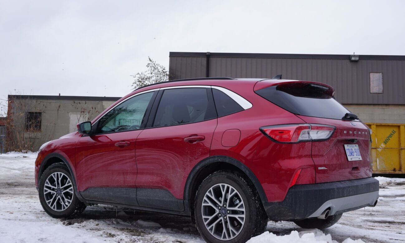 A red Ford Escape sits in a snowy parking lot