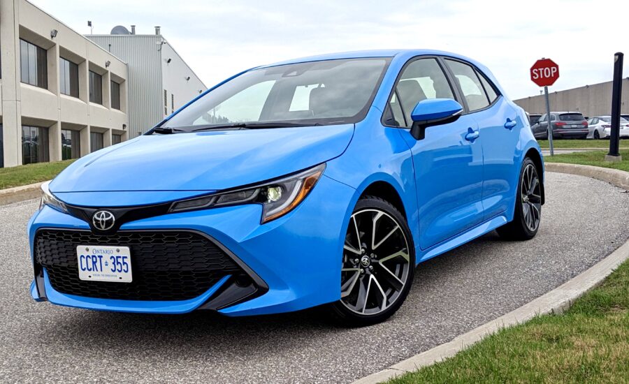 A blue Toyota Corolla sits on a long driveway