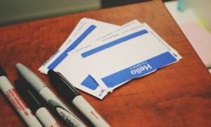 Hello name stickers alongside markers, to symbolize a beneficiary deciding on the name to write down