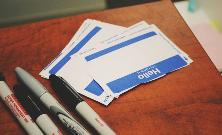 Hello name stickers alongside markers, to symbolize a beneficiary deciding on the name to write down