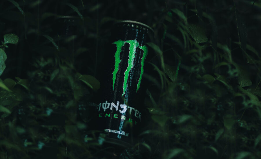 A can of Monster Energy drink coming out of darkness to symbolize its stealth growht