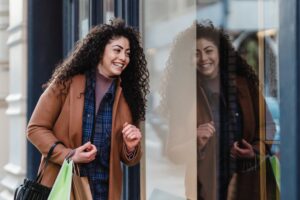 a young woman looks into a store window