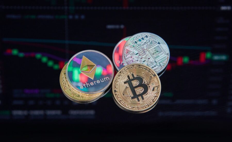 Five coins with crypto logos sit on a graph.