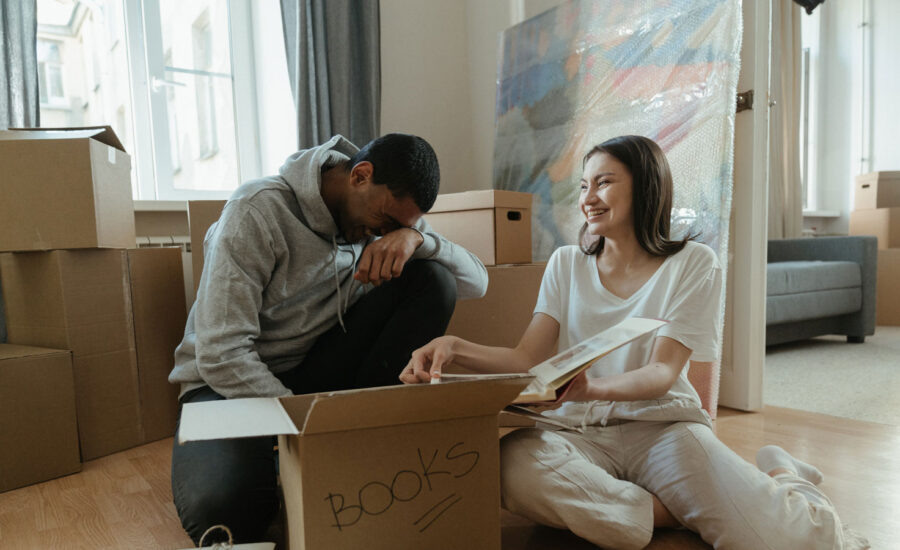 A couple are looking at a photo book, as they clear up the home of a family member. They're also at the stage of wondering the next steps, including who will pay for the mortgage