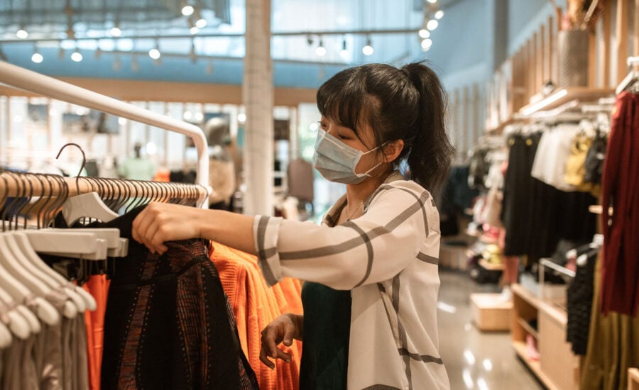 A woman is seen shopping for clothes as she tries to get a deal