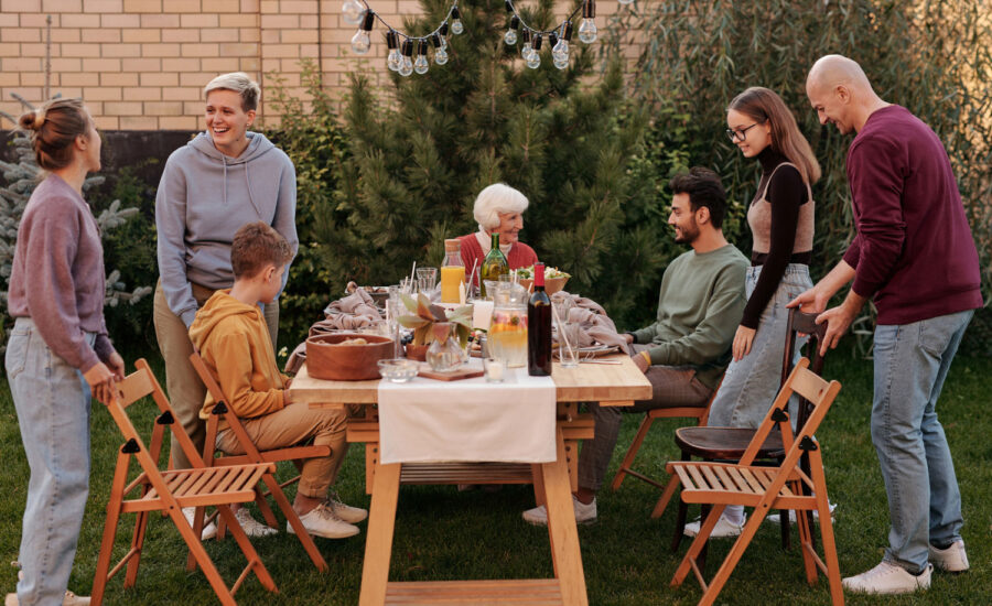To symbolize a split estate, a matriarch is seated at the head of the table with her family grabbing seats at both sides.