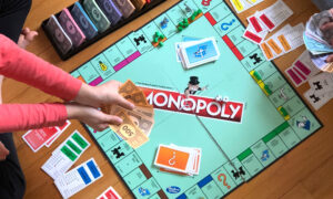 A monopoly game is in session, symbolising how a couple could owe each other money with spousal loan strategy.