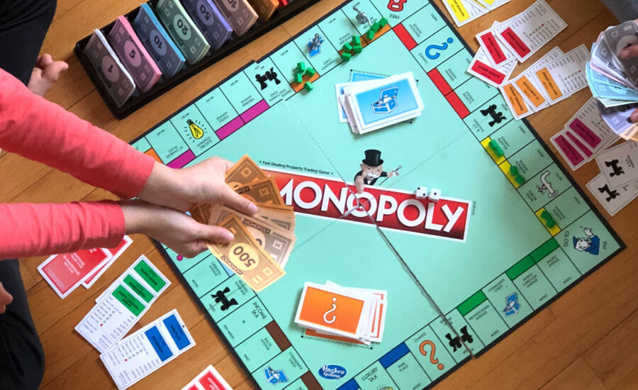 A monopoly game is in session, symbolising how a couple could owe each other money with spousal loan strategy.
