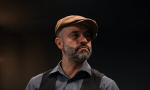 Portrait of a photo of a man in his 50s, with a thoughtful look on his face as he ponders if he needs a financial plan