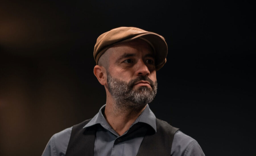 Portrait of a photo of a man in his 50s, with a thoughtful look on his face as he ponders if he needs a financial plan