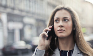 A female Canadian investor is on the phone, talking with her advisor to find out if she can put mutual fund fees back into her account.