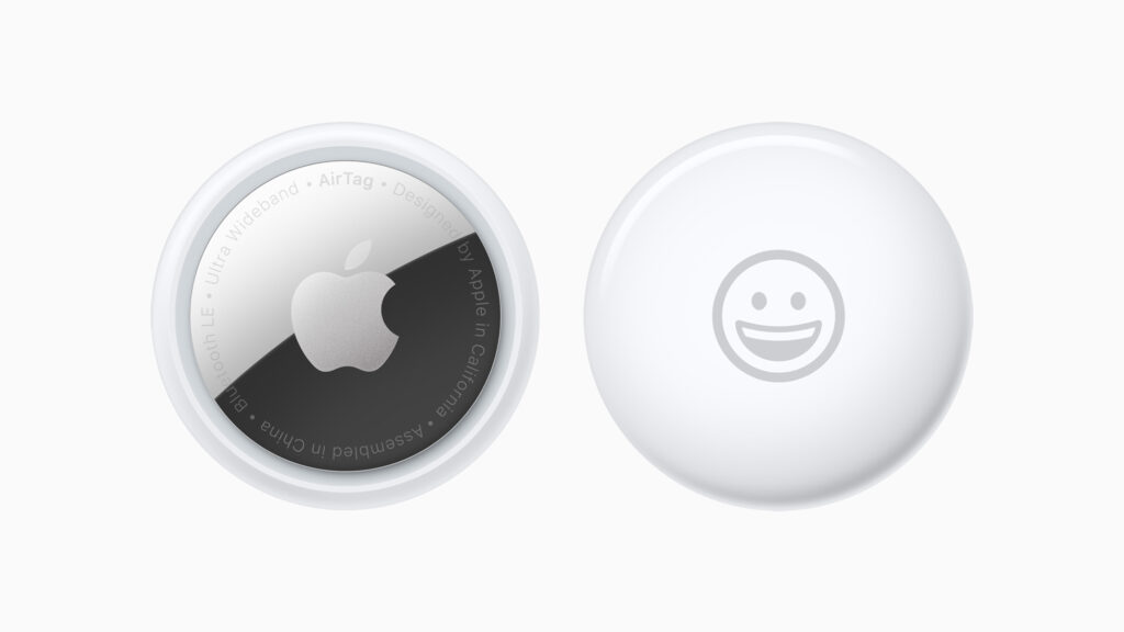 Round white discs, one with an Apple logo, one with a smiling face emoji