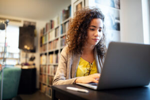 Young woman using a laptop in her living room