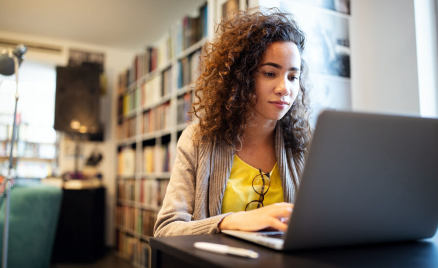 Young woman using a laptop in her living room