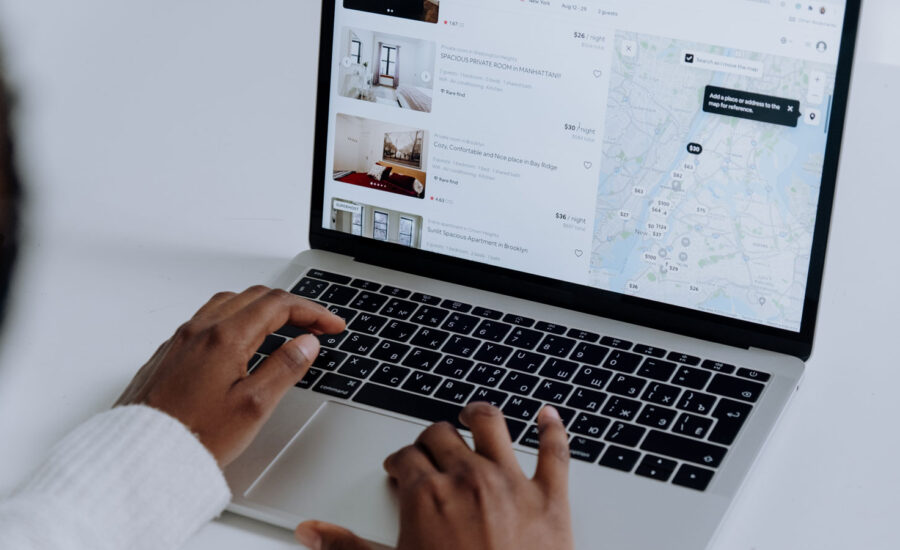 Hands are shown, typing on a laptop, to tie into the earnings reports below.