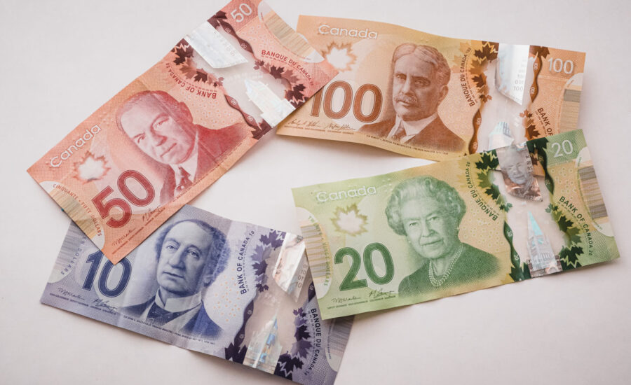 Multiple ranges of Canadian bills to symbolize the different levels of tax brackets in Canada for 2022.