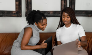 Two women looking at their wills, deciding whether or not to name each other on the registered accounts