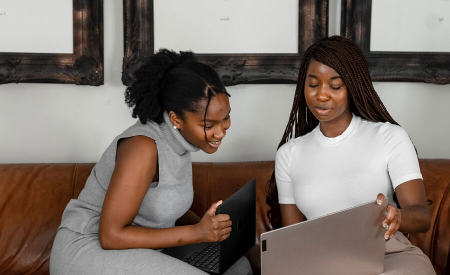 Two women looking at their wills, deciding whether or not to name each other on the registered accounts