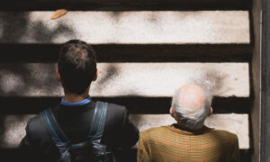 A young man and an older man walking up stairs. This symbolizes how much you need to retire by starting to invest in your 20s