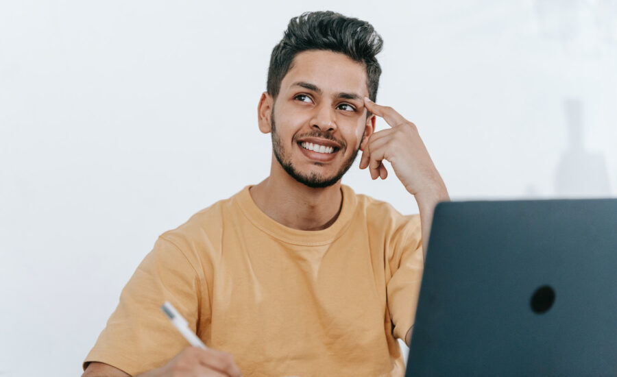 A young man is smiles as he considers ways to minimize his capital gains tax