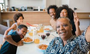 A retiree with her adult child's own family at their first home, thanks to the FHSA