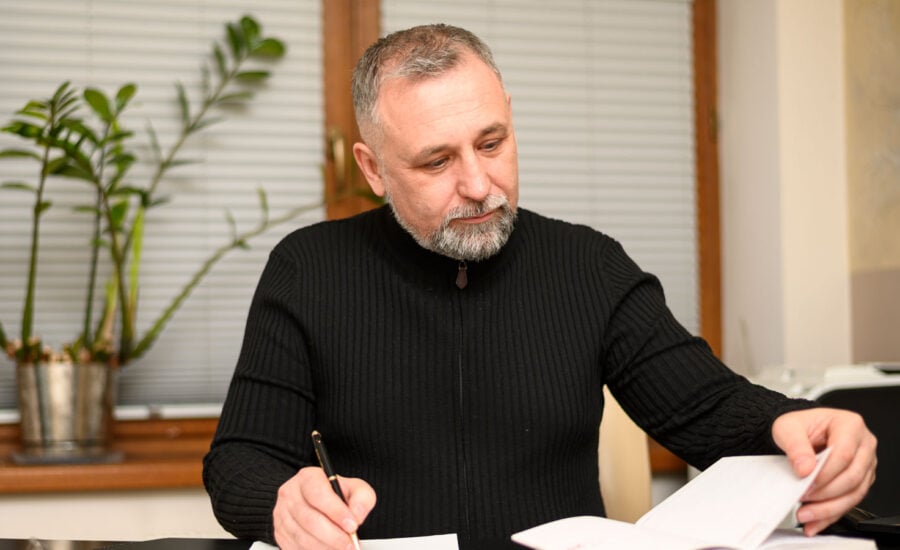 Man is reading the T5 from cashing in his whole life insurance policy, and checking his notes from when he bought it.